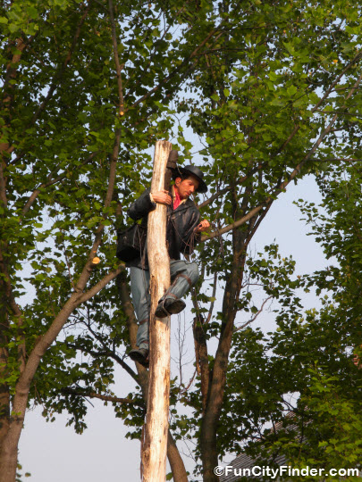 Civil War re-enactor scales a tree at Conner Prairie