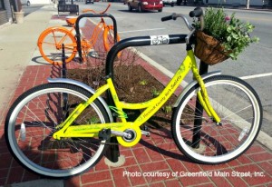 Bright yellow bike with a basket of herbs
