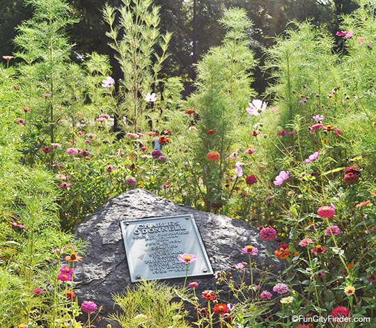Historic Charles O'Donnell plaque on a rock surrounded by flowers in Greenfield, Indiana
