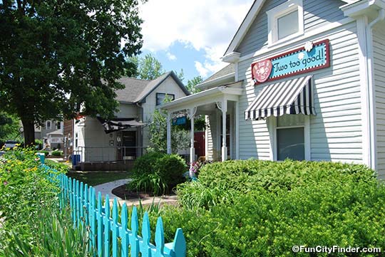 Photo of the Just Pop In popcorn store and cute teal fencing near The Monon Trail in Broad Ripple Village